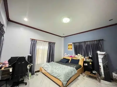 Spacious bedroom with modern decor and ample natural light
