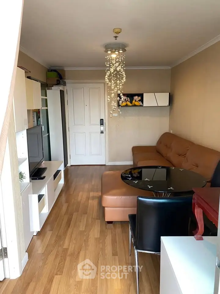 Charming living room with modern decor and cozy seating in a stylish apartment.