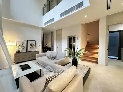 Luxurious modern living room with high ceilings and elegant decor