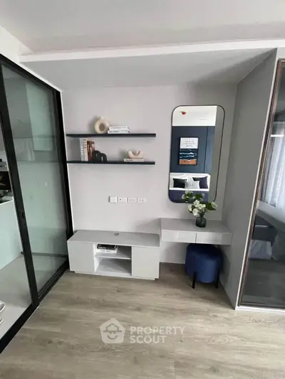 Modern bedroom with sleek design, featuring a mirror, shelves, and a stylish console table.