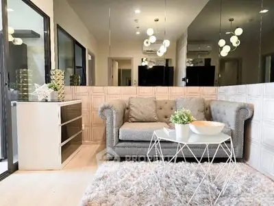 Stylish modern living room with plush sofa, chic decor, and elegant lighting.
