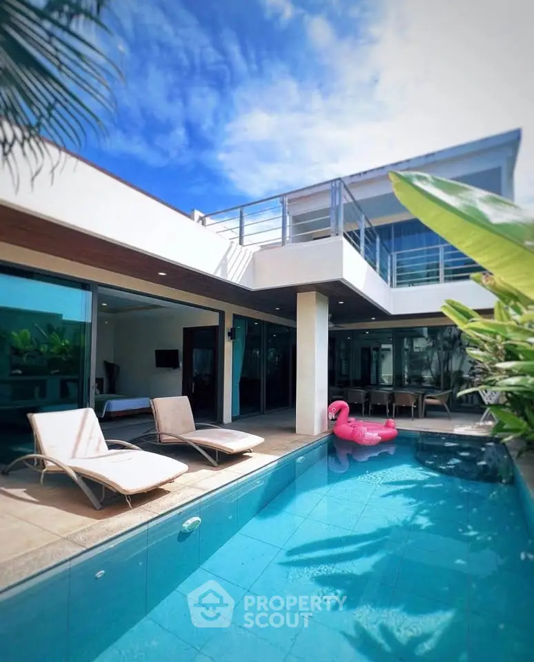 Luxurious modern villa with private pool and sun loungers, perfect for relaxation and entertainment.