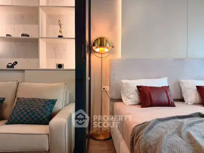 Luxurious modern bedroom with elegant decor and cozy seating area, perfect for relaxation and comfort.