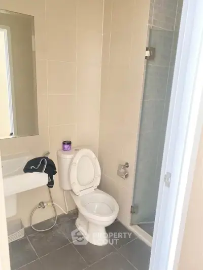 Modern bathroom with glass shower and sleek fixtures in a contemporary home.