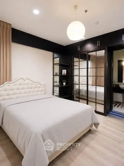 Luxurious bedroom with elegant decor and mirrored wardrobe doors