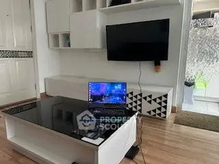 Modern living room with sleek furniture and mounted TV, ideal for tech-savvy homeowners.