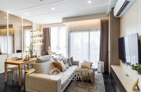 Modern living room with stylish decor, large windows, and cozy seating area in a contemporary apartment.