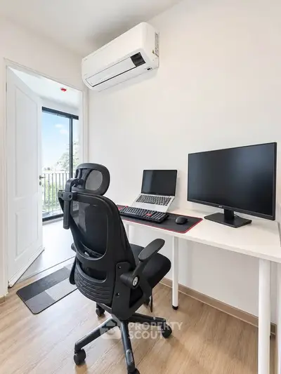 Modern home office with ergonomic chair, dual monitors, and balcony view, perfect for productivity.