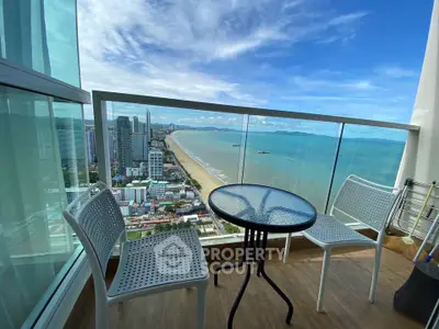 Stunning high-rise balcony with panoramic ocean and city views, perfect for relaxation and enjoying the scenery.