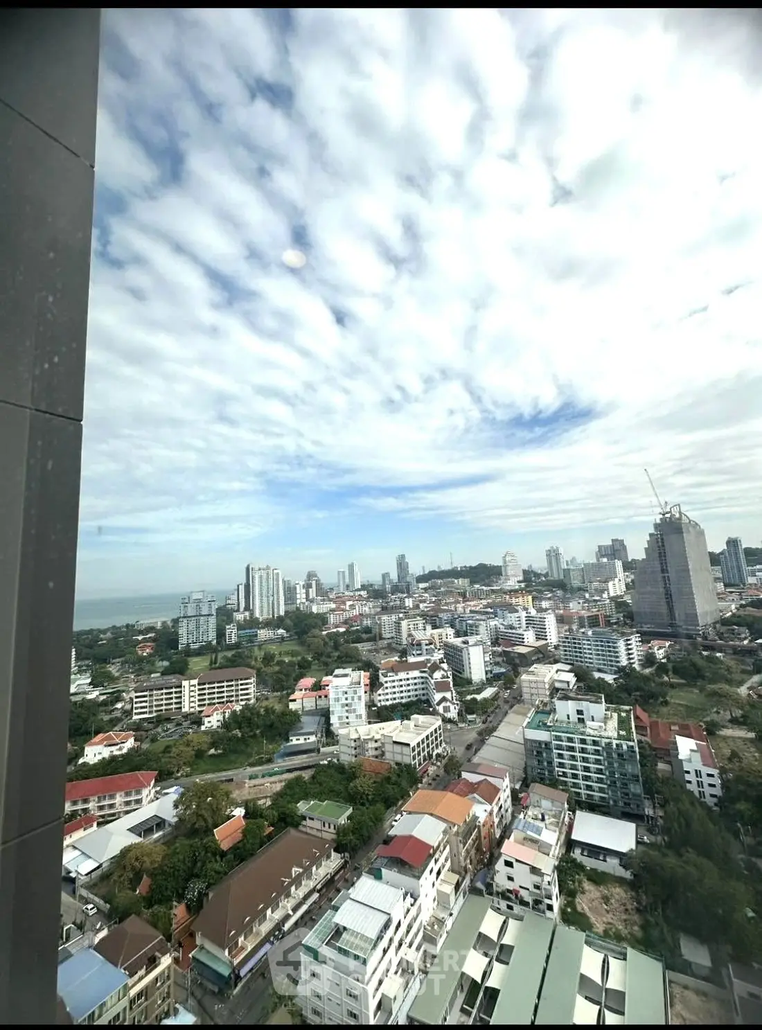 Stunning cityscape view from high-rise building window showcasing urban skyline.