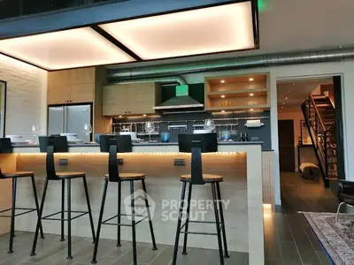 Modern kitchen with stylish bar stools and ambient lighting