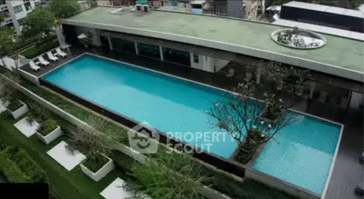 Luxurious rooftop pool with modern design and lush greenery in urban setting.