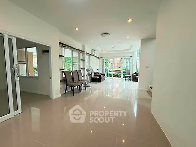 Spacious living room with modern design and large windows offering natural light.