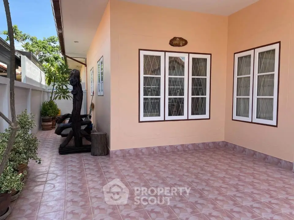 Charming exterior patio with tiled flooring and decorative elements, perfect for relaxation.