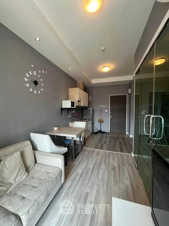Modern living room with open kitchen and stylish decor in a cozy apartment.