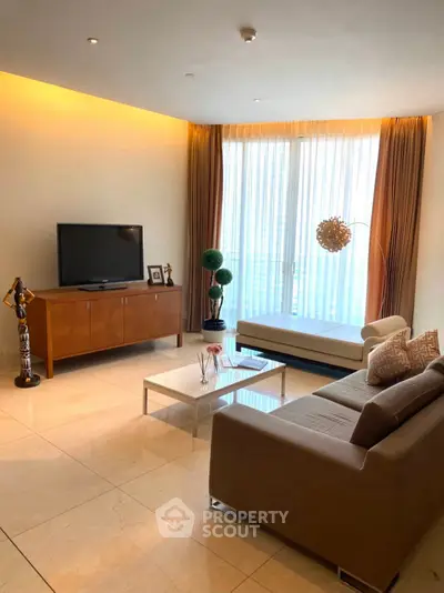 Luxurious living room with modern decor and large windows offering natural light.