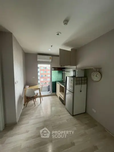 Cozy modern kitchen with dining area and balcony view