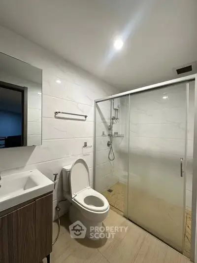 Modern bathroom with sleek shower enclosure and elegant fixtures