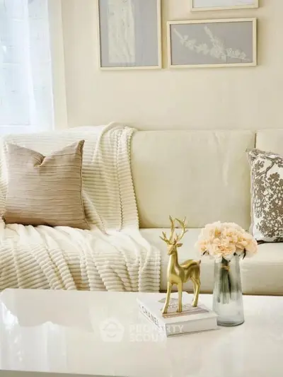Elegant living room with cozy sofa, decorative pillows, and stylish decor accents.