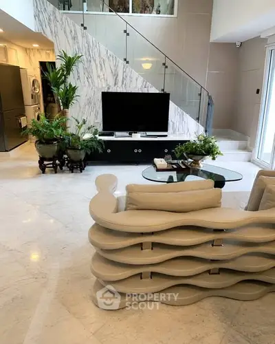 Luxurious modern living room with unique wavy sofa and elegant marble staircase