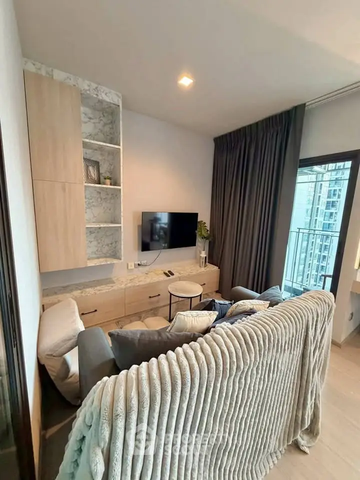 Modern living room with cozy sofa and city view balcony