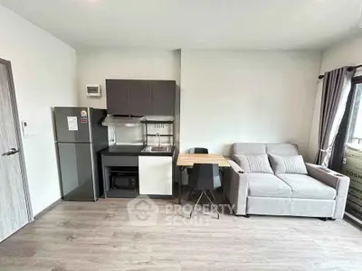 Modern studio apartment with compact kitchen and cozy living area