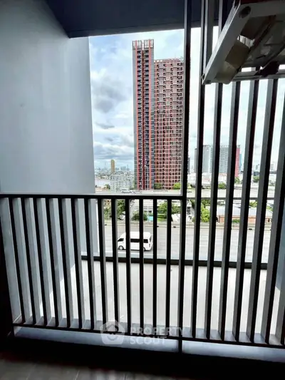 Modern balcony with city view in high-rise building, perfect for urban living.