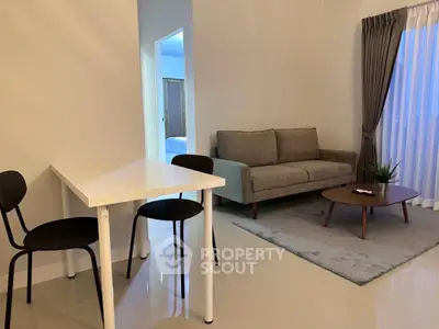 Modern living room with stylish furniture and natural light, perfect for cozy gatherings.