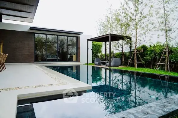 Luxurious modern home with sleek poolside and stylish outdoor seating area.