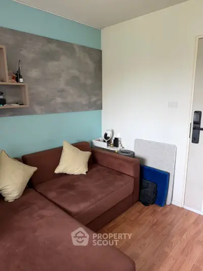 Cozy living room with brown sofa and modern decor, perfect for relaxation.