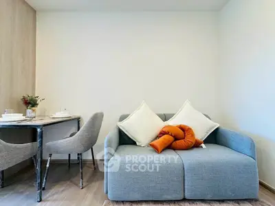 Modern living room with stylish sofa and dining area, perfect for cozy urban living.