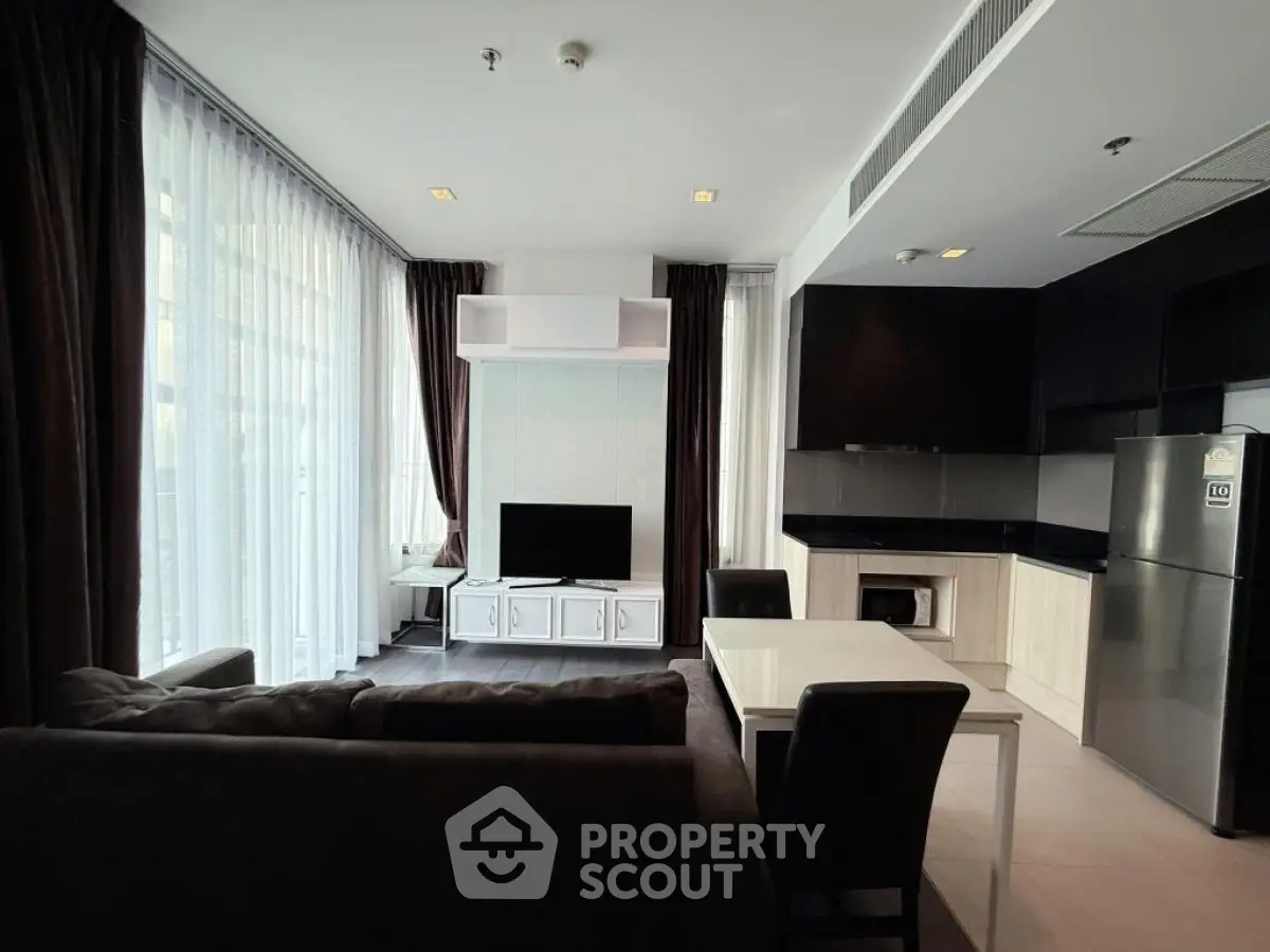 Modern living room with sleek furniture and large windows in a stylish apartment.