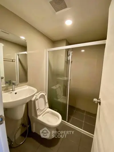 Modern bathroom with glass shower and sleek fixtures