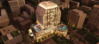 Luxurious high-rise building with stunning rooftop pool and cityscape view at night.