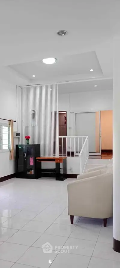 Spacious modern living room with elegant white decor and stylish furniture