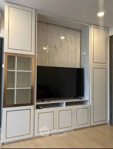Modern living room with sleek built-in TV cabinet and marble accents