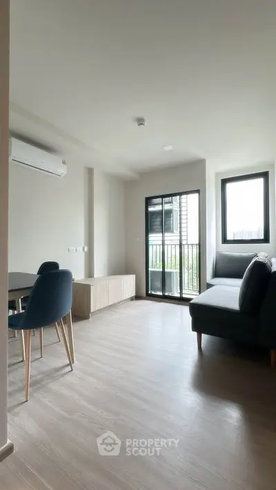 Modern living room with balcony access and stylish furniture