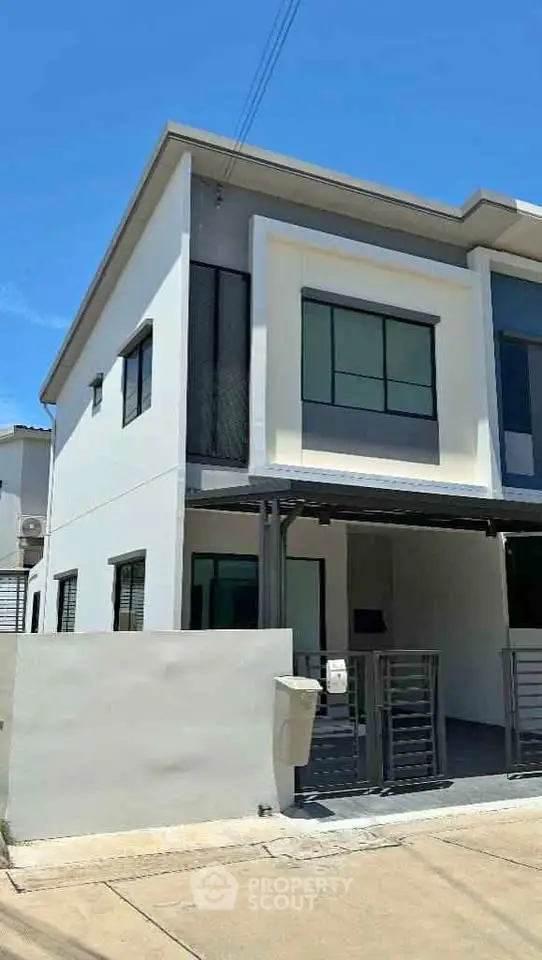 Modern two-story townhouse with sleek design and large windows