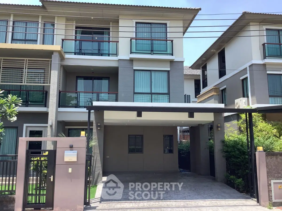 Modern three-story townhouse with spacious balcony and covered parking in a serene neighborhood.
