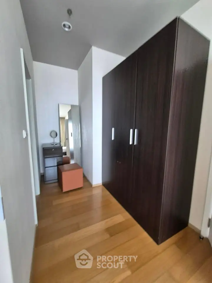 Spacious hallway with wooden flooring and modern wardrobe in a stylish apartment.