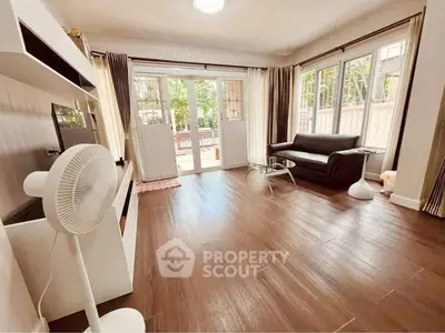 Spacious living room with modern decor and large windows for natural light.