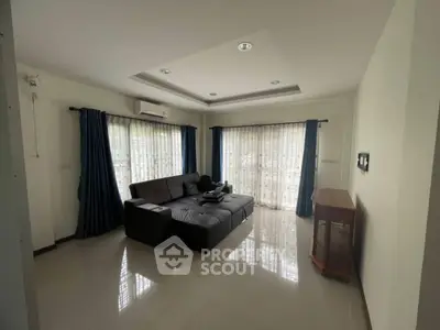Spacious living room with modern sofa and large windows for natural light