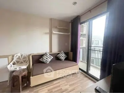 Cozy living room with modern decor and balcony view in urban apartment