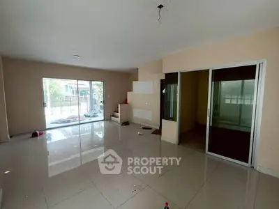 Spacious unfurnished living room with large windows and sliding doors