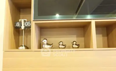 Modern wooden shelving with decorative ducks and digital clock