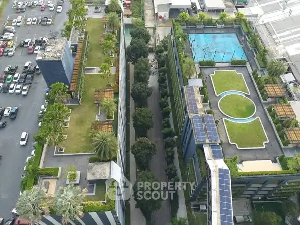 Aerial view of modern building with rooftop gardens and pool area