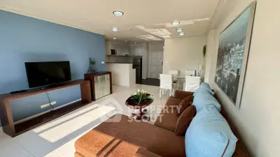 Spacious living room with modern decor and open kitchen layout