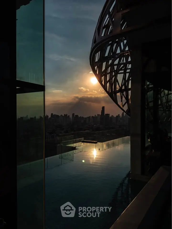 Stunning rooftop pool with breathtaking city skyline view at sunset.