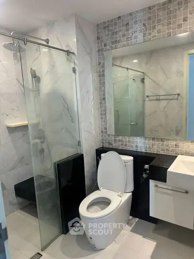 Modern bathroom with glass shower and sleek fixtures