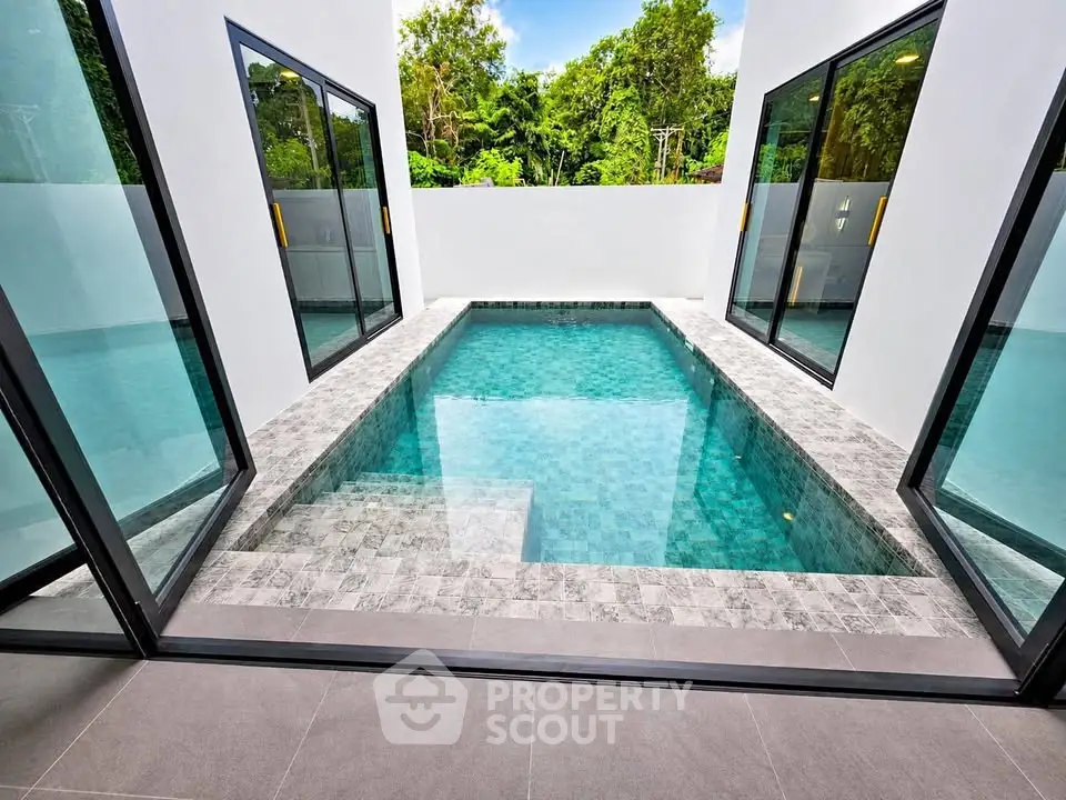 Luxurious private pool with modern design and lush greenery view